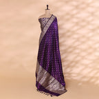 Full-length view of the amethyst purple Banarasi silk unstitched suit draped on a mannequin, showcasing the gold booties pattern and an intricate floral zari border.