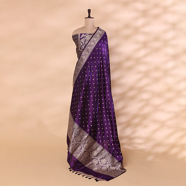 Full-length view of the amethyst purple Banarasi silk unstitched suit draped on a mannequin, showcasing the gold booties pattern and an intricate floral zari border.