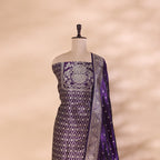 A detailed close-up shot of the pure handwoven amethyst purple Banarasi silk fabric, highlighting the premium texture and fine gold handloom zari work.