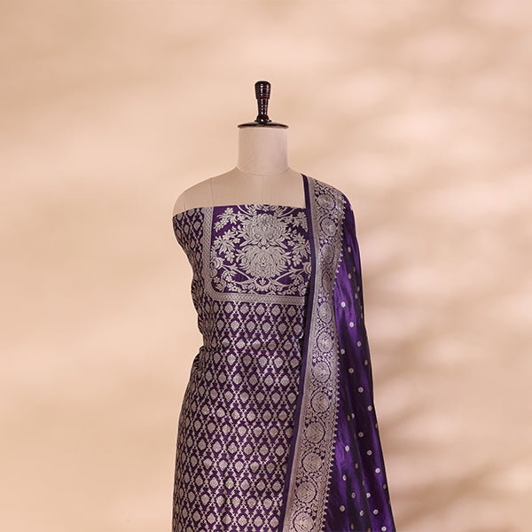 A detailed close-up shot of the pure handwoven amethyst purple Banarasi silk fabric, highlighting the premium texture and fine gold handloom zari work.