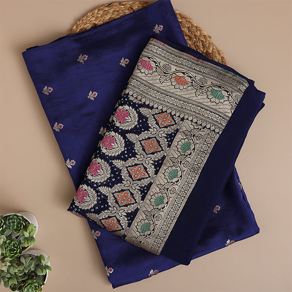 Close-up shot of the premium sapphire blue pure Banarasi silk dress material, highlighting the luxurious handloom fabric texture and intricate metallic zari bootis.