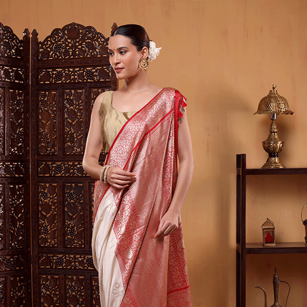 Close-up view of the premium handwoven scarlet silk fabric, showcasing the fine texture and the detailed craftsmanship of the traditional gold Sauna Roopa border.