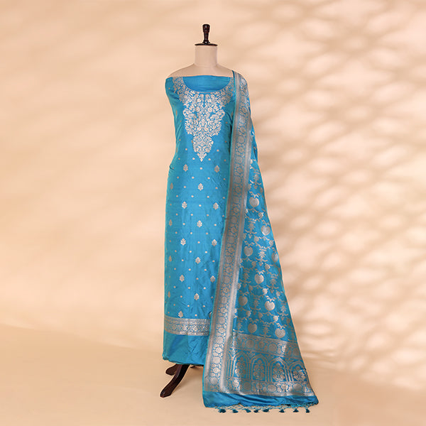 Detailed shot of the captivating aqua blue pure silk dress material showcasing the intricate traditional full Jaal handwoven design by Banarasi artisans.