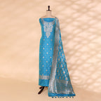 Detailed shot of the captivating aqua blue pure silk dress material showcasing the intricate traditional full Jaal handwoven design by Banarasi artisans.