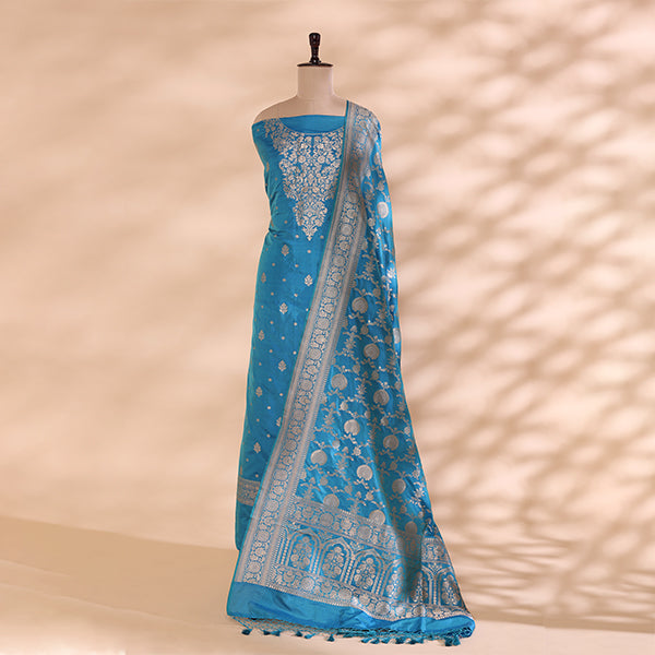 Pure handwoven Banarasi Silk unstitched suit in a captivating aqua blue shade displayed on a mannequin, featuring an intricate full Jaal design and elegant neck pattern.
