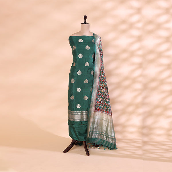 Pure handwoven Patola Silk unstitched suit featuring a serene ocean mist green base displayed on a mannequin, paired with a vibrant multicolored kaleidoscopic dupatta.