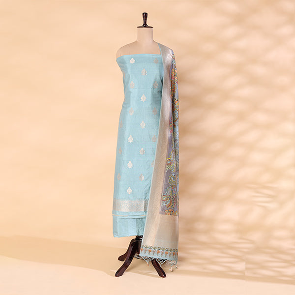 Pure handwoven Banarasi Silk unstitched suit in sky blue displayed on a mannequin, featuring an intricate traditional weave paired with a multicolored digital Kalamkari dupatta.