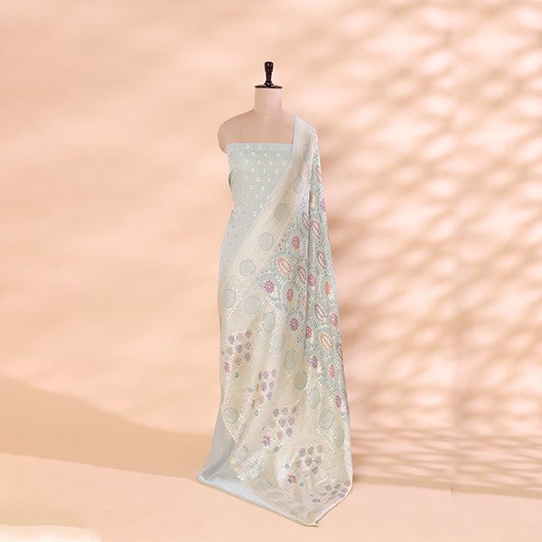 Pure handwoven Georgette Silk unstitched suit in a soothing mint green shade displayed on a mannequin, featuring intricate Meena and Resham work paired with a vibrant multicolor dupatta.