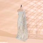 Pure handwoven Georgette Silk unstitched suit in a soothing mint green shade displayed on a mannequin, featuring intricate Meena and Resham work paired with a vibrant multicolor dupatta.