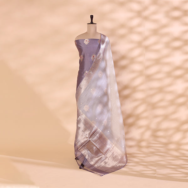Detailed shot of the luxury shimmering silver dupatta highlighting its rich reflective texture, elegant festive borders, and traditional handwoven craftsmanship.