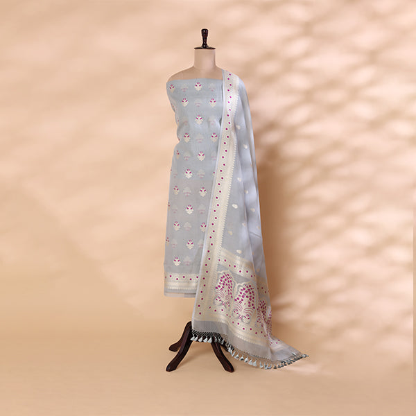 Handwoven pure Organza Silk unstitched suit in a serene silver-blue hue displayed on a mannequin, featuring intricate Meena and Zari work with a matching Zari dupatta.