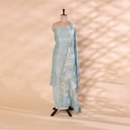 A traditional Banarasi georgette suit in sky blue with intricate Zari work and a leaf pattern on the dupatta, displayed on a mannequin against a neutral background