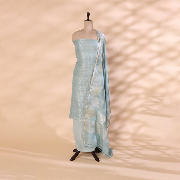 A traditional Banarasi georgette suit in sky blue with intricate Zari work and a leaf pattern on the dupatta, displayed on a mannequin against a neutral background