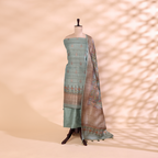 Pure handwoven Tussar Silk unstitched suit featuring a serene sky blue dress material displayed on a mannequin with a traditional handprinted multicoloured Kalamkari pattern dupatta.