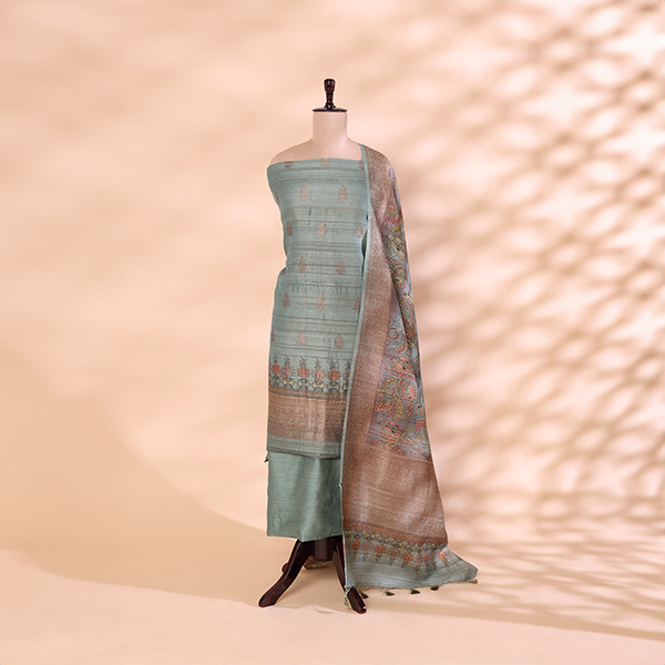 Pure handwoven Tussar Silk unstitched suit featuring a serene sky blue dress material displayed on a mannequin with a traditional handprinted multicoloured Kalamkari pattern dupatta.