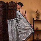 Close-up shot of the heavy, opulent pallu on the white katan silk saree, showcasing traditional Banaras handloom craftsmanship.