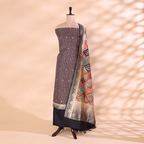 A mannequin displaying an elegant striped silk unstitched suit paired with a vibrant, multicolored traditional patchwork dupatta, featuring intricate woven borders.