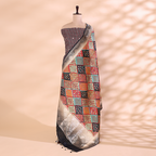 A mannequin displaying an elegant striped silk unstitched suit paired with a vibrant, multicolored traditional patchwork dupatta, featuring intricate woven borders.