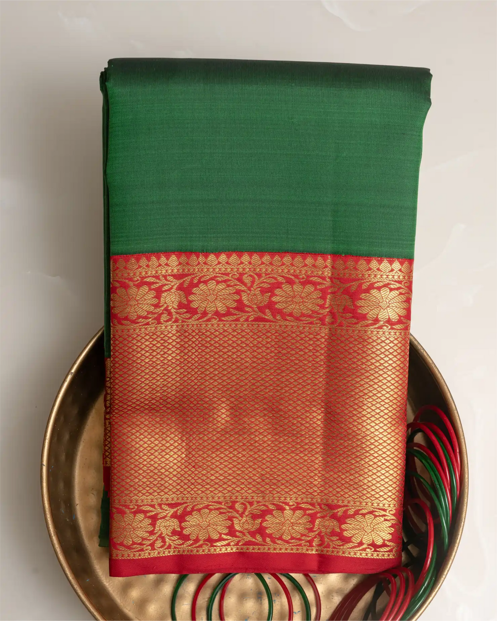 A styled look featuring the emerald green Kanjivaram silk saree paired with traditional temple jewelry.
