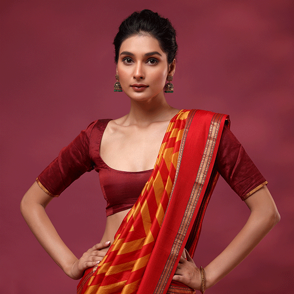 Close-up view of the 1-meter plain dark red silk unstitched blouse material with a matching double border included with the saree.