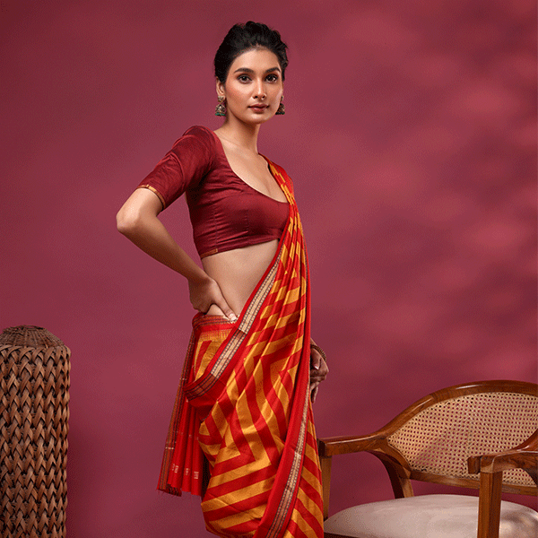 Detailed view of the Sunlit Symphony saree showcasing the vibrant, harmonious blend of radiant yellow and red handwoven stripes across the silk fabric.