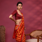 Detailed view of the Sunlit Symphony saree showcasing the vibrant, harmonious blend of radiant yellow and red handwoven stripes across the silk fabric.
