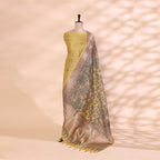 Pure handwoven Banarasi silk unstitched suit featuring a soft sunlit yellow base displayed on a mannequin with a handprinted multicoloured Kalamkari dupatta.