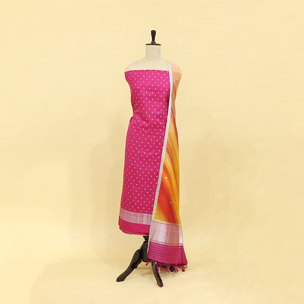 Handwoven sweet pink tie and dye silk unstitched suit displayed on a mannequin, featuring shiny silver work on the body and an enchanting multicoloured ombre dupatta.