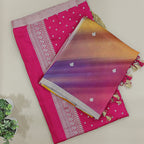 Close-up shot of the premium sweet pink tie and dye silk fabric highlighting the intricate traditional handloom weave and shiny silver accents.