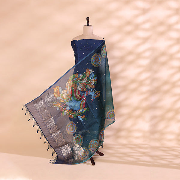 A mannequin displaying a luxurious teal-blue handwoven silk dupatta, featuring intricate peacock and circular mandala motifs with detailed zari border work.