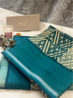 Close-up of a teal cotton fabric with an intricate geometric pattern, displayed with an ARZO branded gift box.