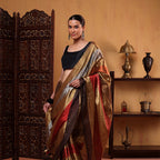 Detailed view of the pure tissue saree showcasing the intricately handwoven strips in natural, earthy tones and artisan craftsmanship.