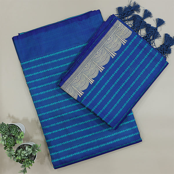 Close-up shot of the tranquil blue pure Satin Silk dress material, showcasing the detailed traditional handloom weave and fine metallic silver resham strips.