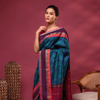 Detailed view of the Banarasi silk saree's elegant drape, showcasing the striking tri-color border contrast blending dawn pink, twilight blue, and dusky gold.
