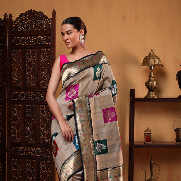 The handwoven unstitched Tussar silk blouse material featuring delicate zari bootas and an elegant resham border.