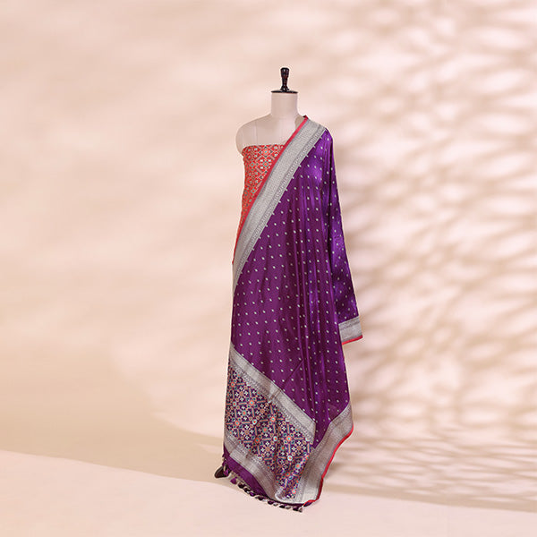 Close-up shot of the luxurious twilight amethyst pure handloom Patola Banarasi silk fabric detailing the intricate Resham and Zari weaving.
