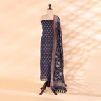 Pure handloom Cotton Mull Jamdani unstitched suit featuring a twilight plum base displayed on a mannequin with a vibrant, radiant prismatic dupatta.