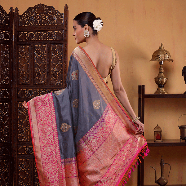 Detailed view of the premium handwoven Katan silk saree showcasing the contrasting border in striking shades of grey, pink, and purple.