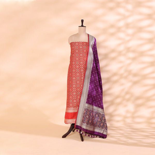 Pure handwoven Patola Banarasi Silk unstitched suit featuring a twilight amethyst base displayed on a mannequin with a vibrant sunset spectrum multicoloured dupatta.