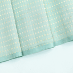 Exquisite silver and gold zari embroidery details on a pastel green handloom Banarasi cotton saree, perfect for weddings and festivals.