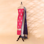 Handwoven cerise Katan Silk unstitched suit displayed on a mannequin featuring a golden border and a deep midnight ocean dupatta with intricate Resham and Zari work.