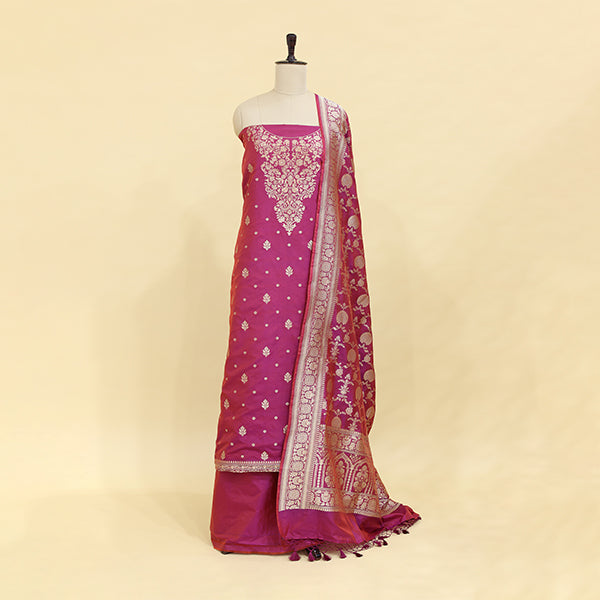 A vintage wine Banarasi silk suit displayed on a mannequin, featuring intricate traditional patterns and a dupatta.