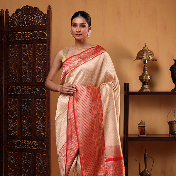 Front view of the White Opulence Banarasi Silk Saree showing the elegant pleats and the vibrant red border with golden brocade accents.