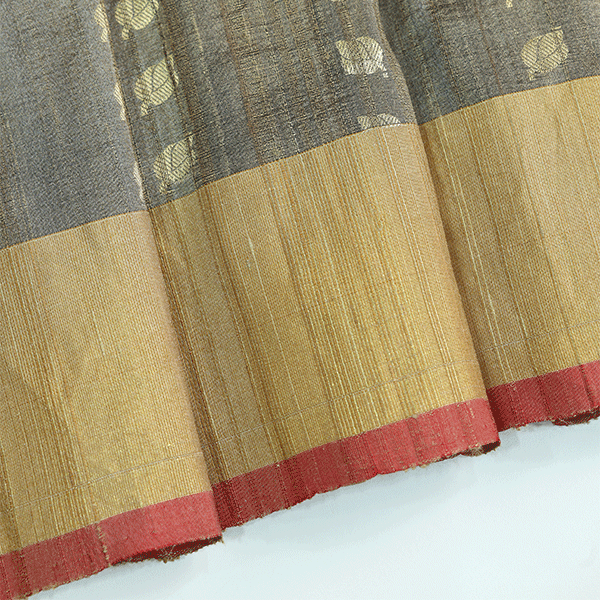 Close-up or flat lay of the unstitched pure silk blouse fabric featuring elegant gold Zari Bootas and a contrasting border.